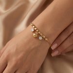 Дамска златна гривна с висящи елементи